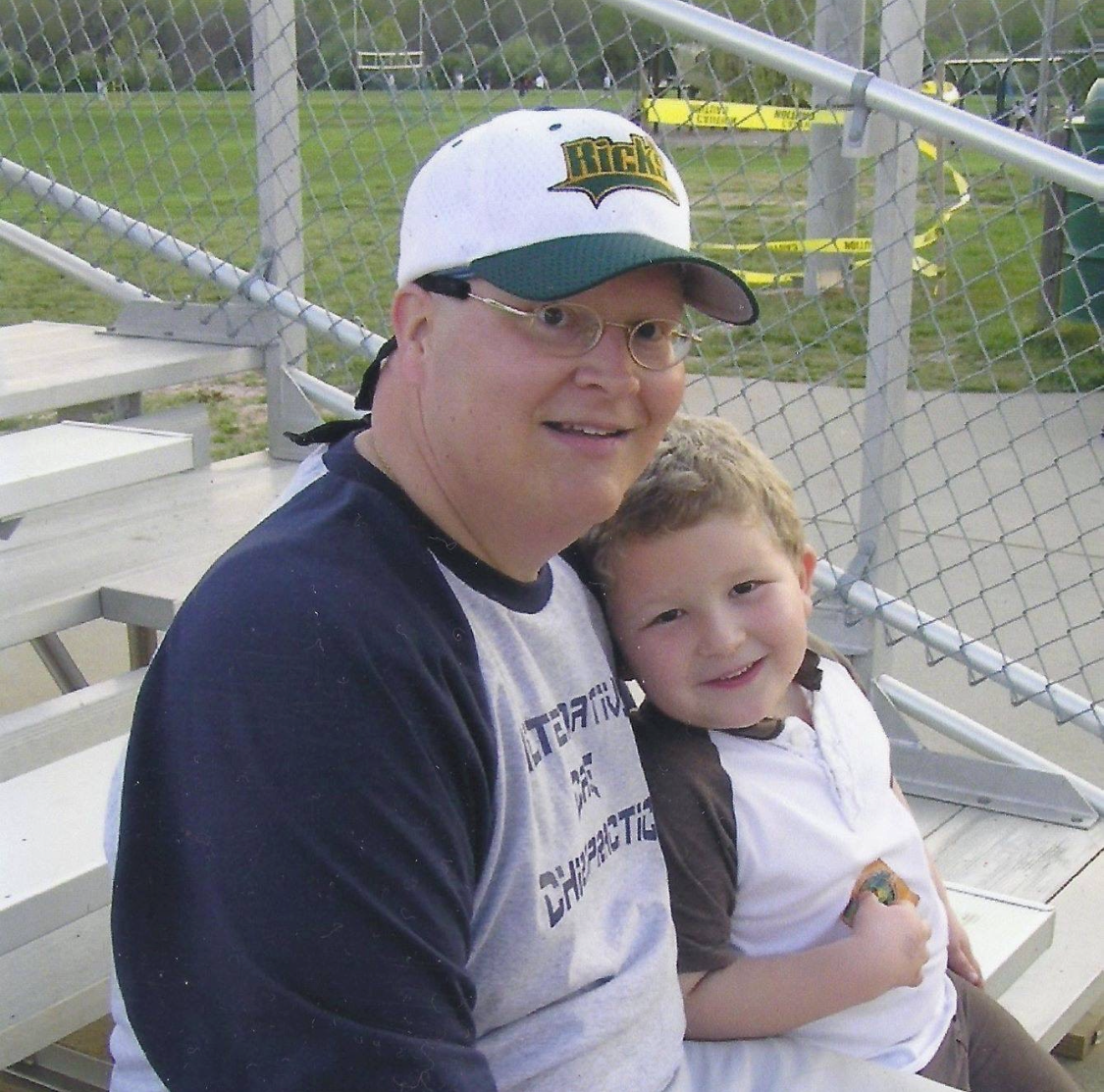 Little Adam and Dad at baseball game